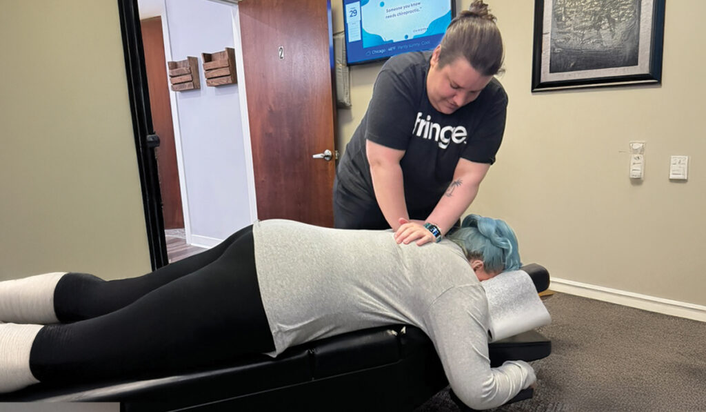 Dr. Katie Carlin performing a chiropractic adjustment on a patient at HealthSource of Chicago-Wicker Park