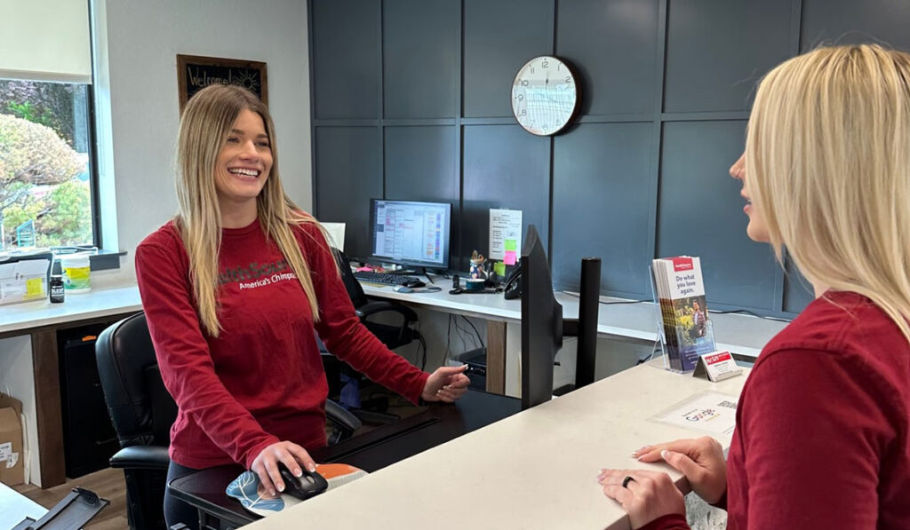 A patient being greeted by the Front Desk Specialist at HealthSource of Meridian