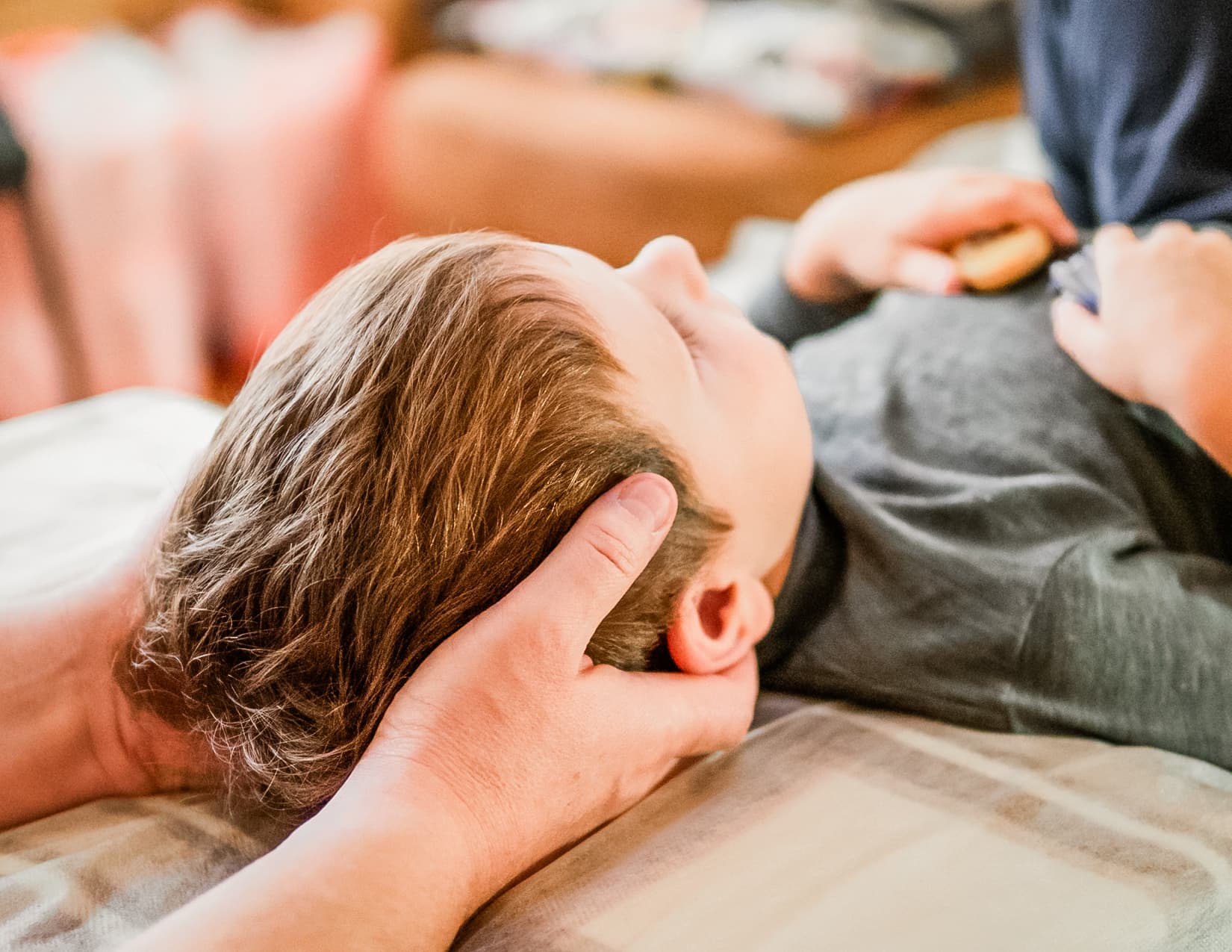 Close up of a practitioner examining a child's neck.